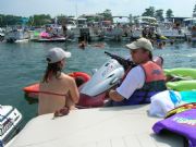 Lake Martin Holding onto jet ski engrossed in coversation enjoying the concert